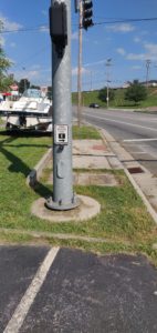 Accessible curb cut blocked by traffic light post